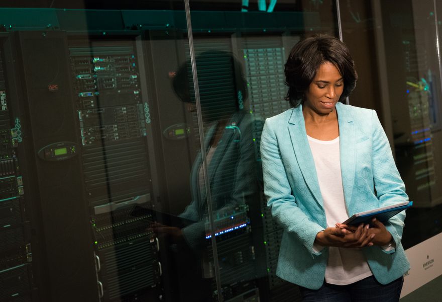 Engineer reviewing systems in a server room